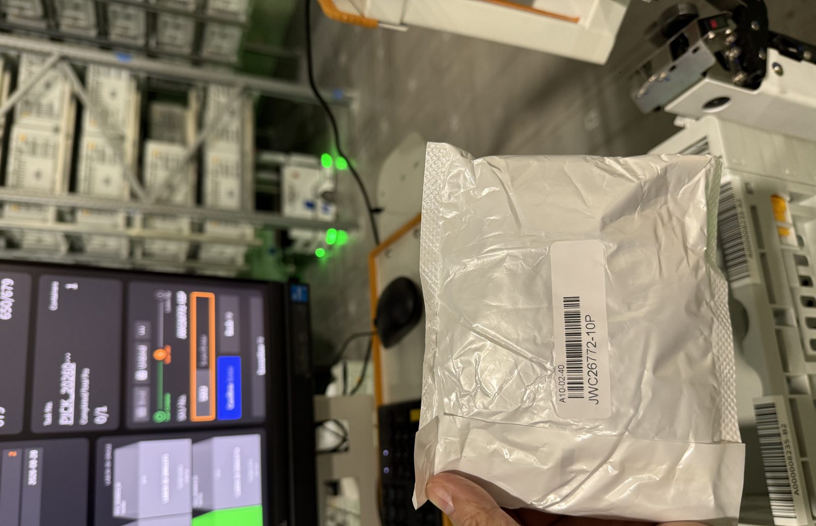 Operator scanning a parcel at a pick station